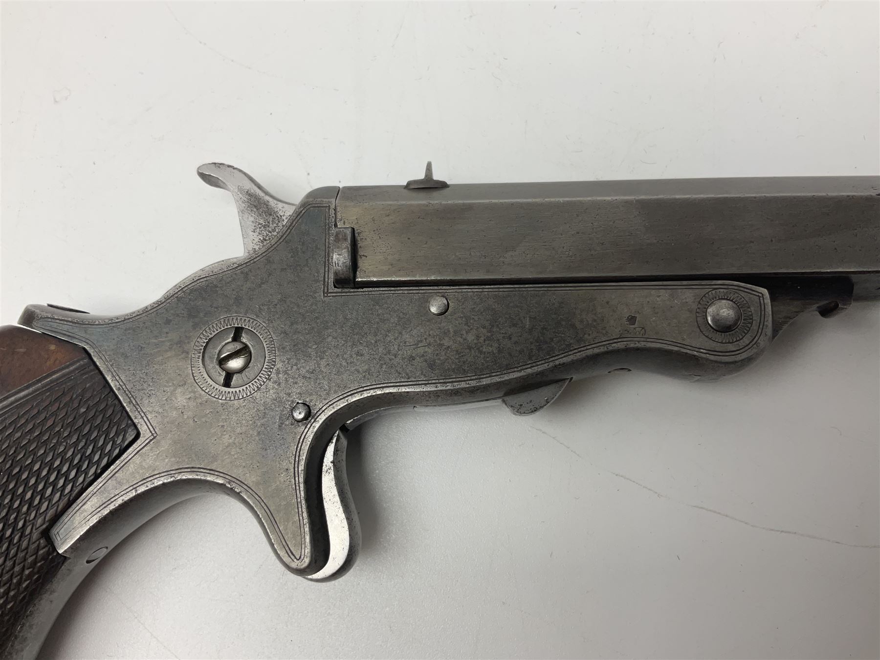 19th century .297/230 rimfire single shot break-action pistol, ''Tranter's Patent'', no.2;  the 25cm octagonal barrel marked Kynoch Gun Factory Aston; fin fore-sight, dove-tail standing notch rear-sight, open iron frame with barrel release button to the integral fore-end, central hammer, spur trigger and chequered walnut one-piece grip with domed iron pommel-cap L36cm overall