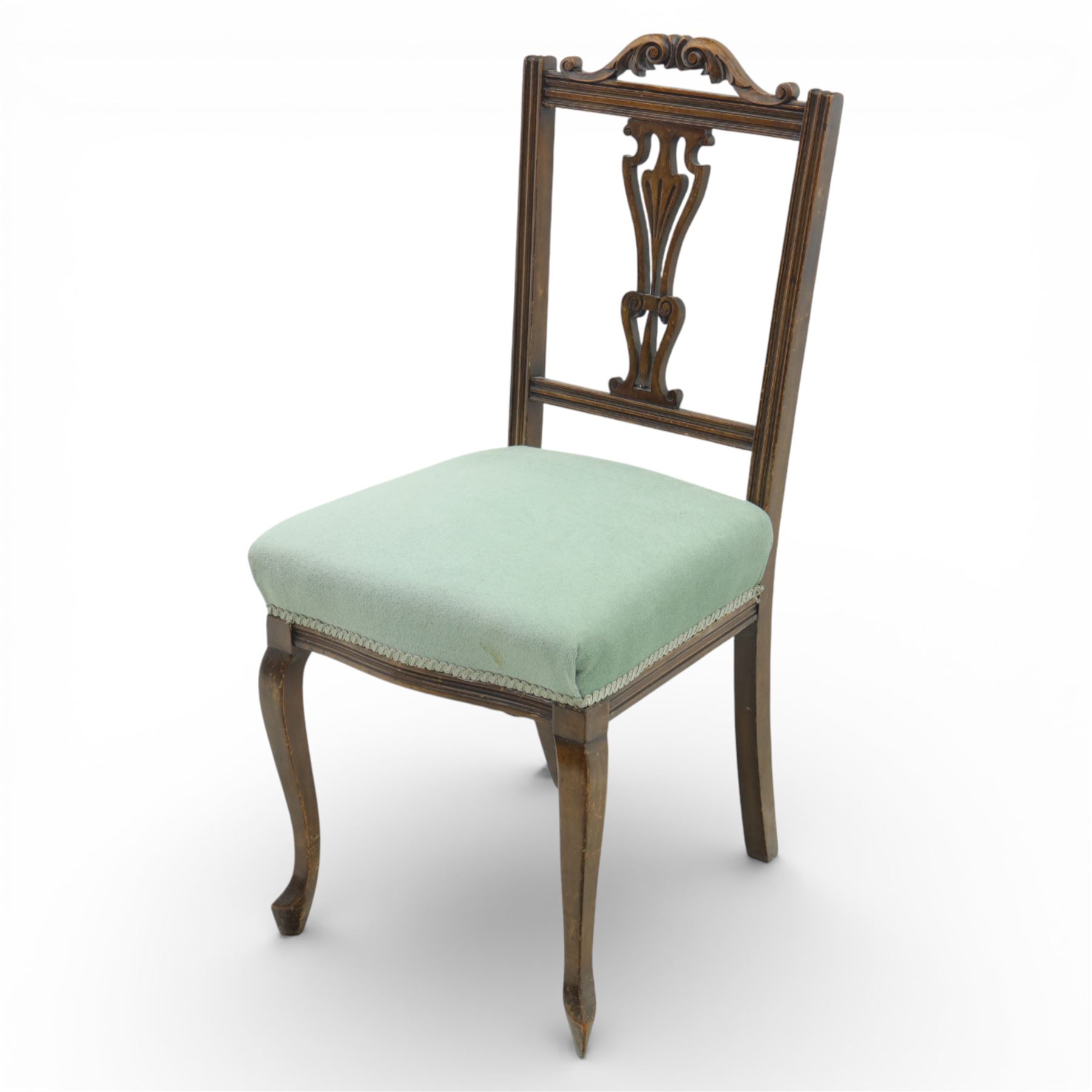 Late Victorian mahogany side chair, the carved cresting rail above a pierced and carved splat with lyre-form detail, the back panel inset with cane work, drop-in upholstered seat in pale green fabric with braid trim, raised on cabriole supports