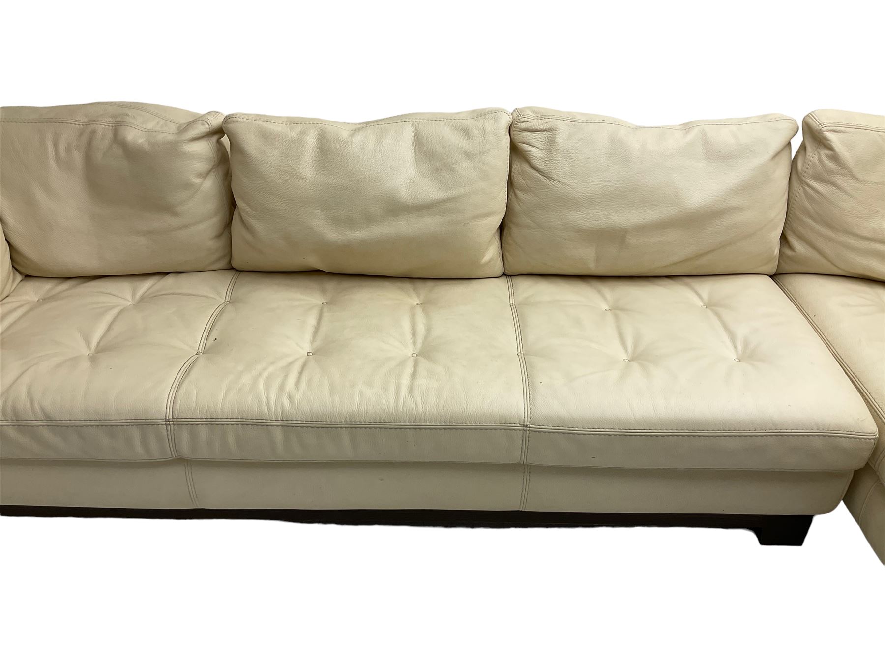 Roche-Bobois - large corner sofa, upholstered in ivory leather with buttoned seat cushions, raised on a stained beech base with bracket feet