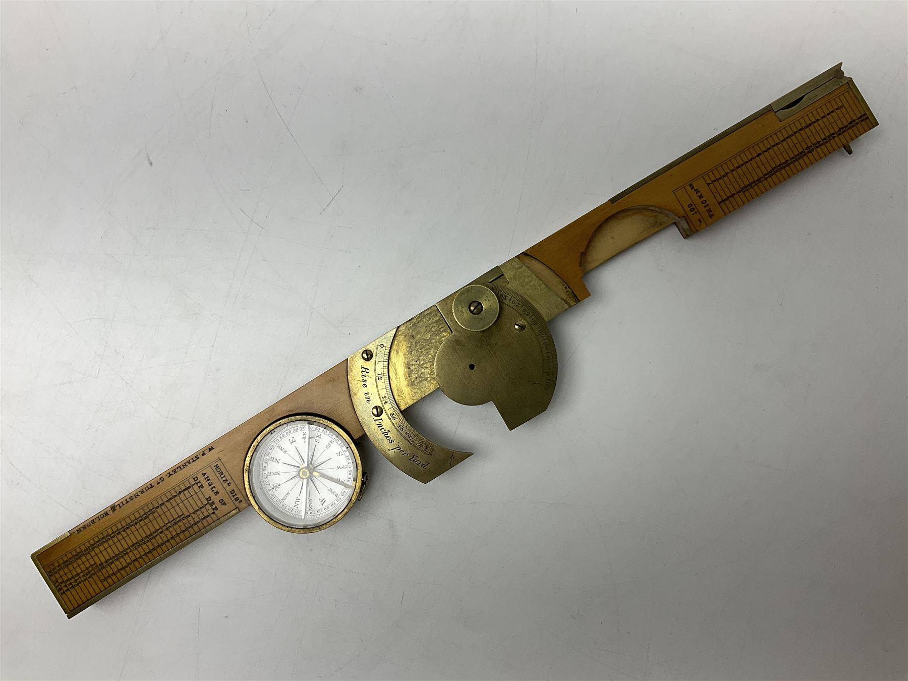 Late 19th/early 20th century boxwood and brass clinometer rule by Stanley, with inset magnetic compass, screw action protractor hinge divided to one degree with rise in inches per yard scale under, spirit level to one edge, marked 'W.F. Stanley Great Turnstile Holborn' with tables of distances, angles and thickness H16cm closed: in original leather covered case with instructions