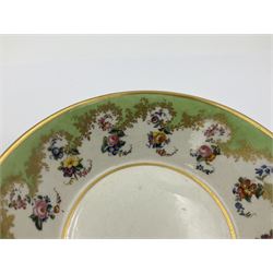 Sèvres soft paste porcelain coffee can and saucer with date code for 1754, painted and gilded with flowers, dangling from the shaped green border, interlaced LL monogram enclosing the date letter A above painters mark for Dodin, coffee can H7cm, saucer D14.5cm