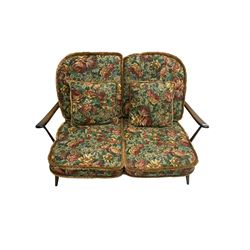 Ercol - dark elm and beech two seater sofa, with loose floral cushions