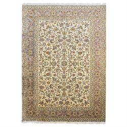 Central Persian Kashan hand-knotted carpet, ivory field decorated with an all-over scrolli...
