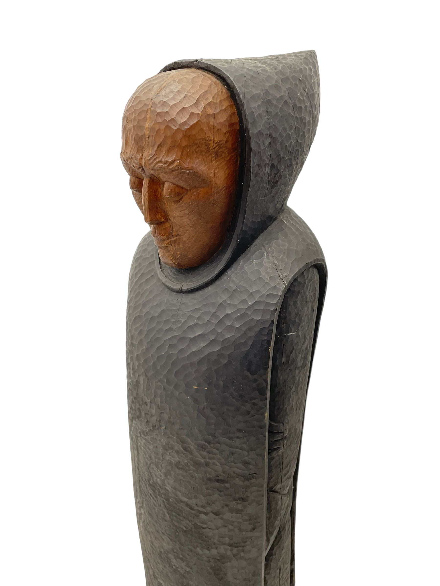 John Bunting FRBS, FRCA (1927-2002): Carved sculpture of a standing Monk in ebonised robes