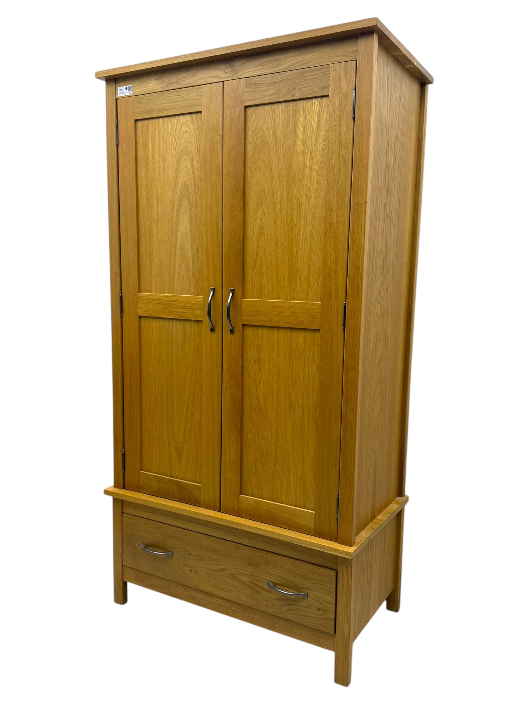 Light oak double wardrobe, hanging rail with single drawer on square legs 