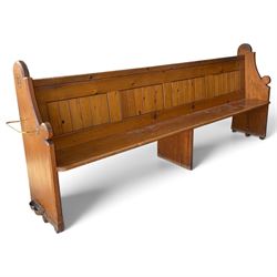 Early 20th century stained pine ecclesiastical church pew, the shaped end supports flankin...