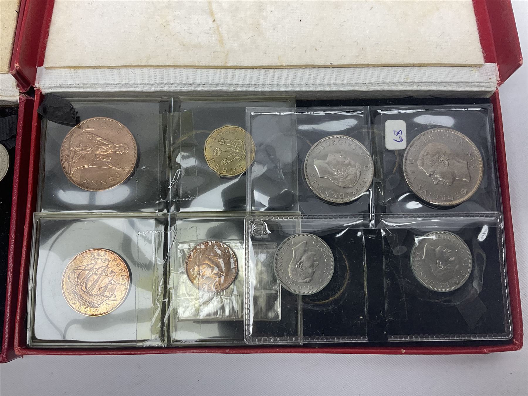 Four King George VI 1950 specimen coin sets, each comprising farthing, half penny, penny, threepence, sixpence, English  one shilling, Scottish one shilling, two shillings and half crown, each in red Royal Mint card case