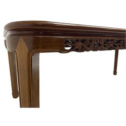 Late 20th century Chinese carved hardwood extending dining table, rectangular panelled top with rounded corners over a pierced frieze carved with dragon motifs and scrolling foliate decoration, with two additional leaves