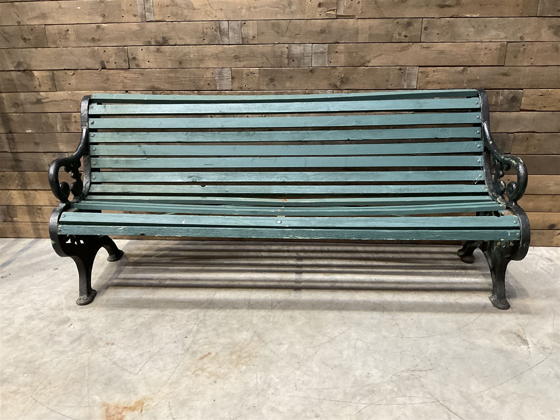 Early 20th century slatted garden bench with scrolling cast iron bench ends