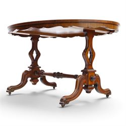 Victorian mahogany breakfast table, oval moulded top over a shaped frieze, on twin pierced lyre-form end supports with moulded scroll feet, united by a turned stretcher, on castors