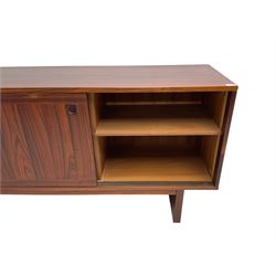 NH Chapman & Co Siesta - mid-20th century sideboard, fitted with three sliding doors, enclosing two drawers and shelves, raised on twin end supports
