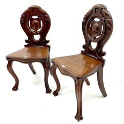 Pair of Victorian mahogany hall chairs, carved and pierced back, serpentine shaped seat, cabriole legs 