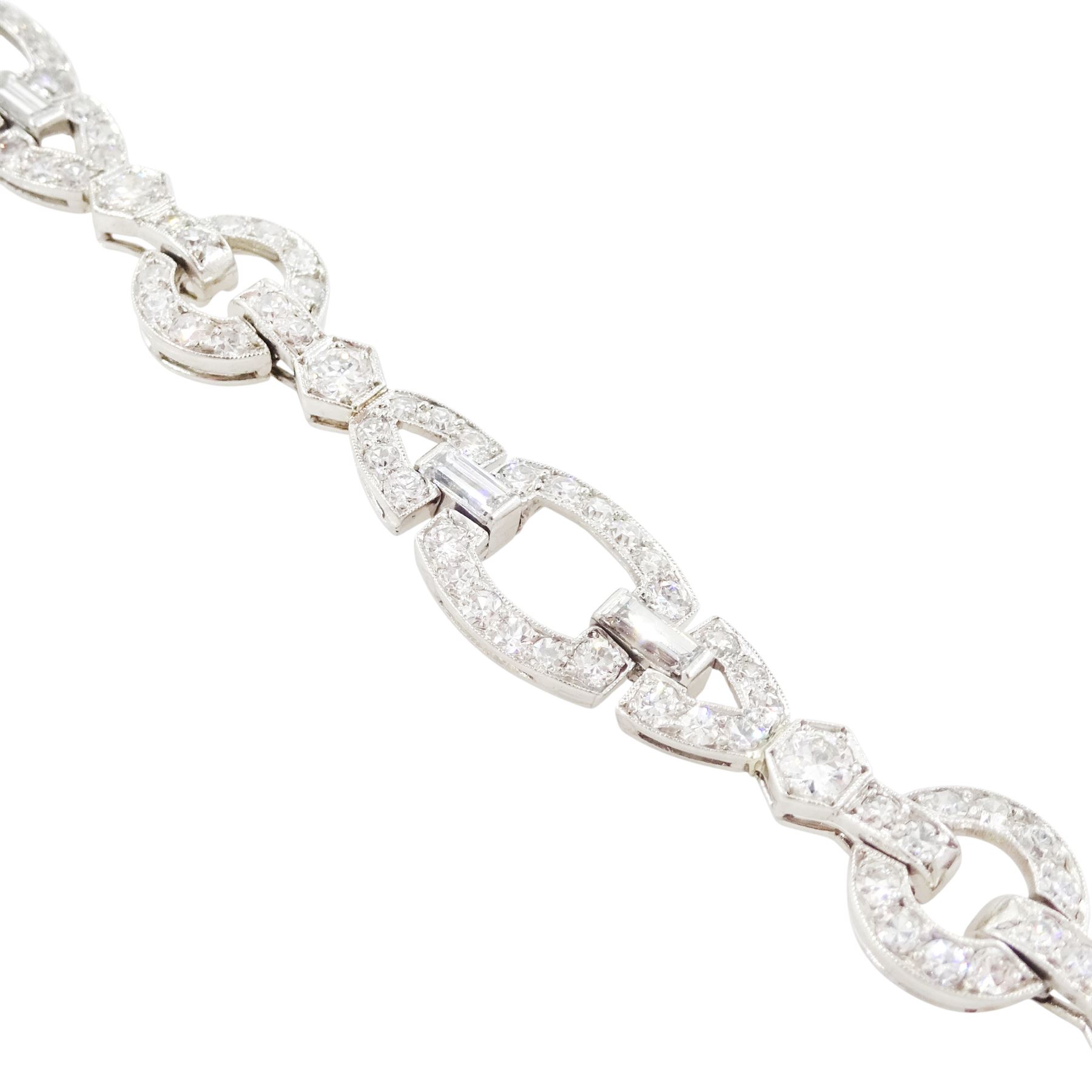 Art Deco platinum diamond bracelet, circa 1920, articulated openwork circular and geometric links, milgrain set with old cut diamonds and baguette cut diamonds, total diamond weight approx 3.85 carat