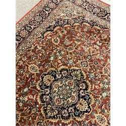 Persian Keshan red and blue ground rug, the field and border decorated with scrolling foliate and stylised flower heads, central medallion 