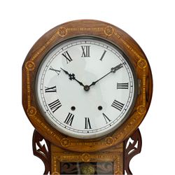 An American late 19th century oak and mahogany drop dial wall clock by Chauncey Jerome & Sons, with inlaid parquetry, fully glazed tablet door with fretwork and visible pendulum, sloped base with silk backed fretwork, 17” wooden bezel and 12” painted steel dial, Roman numerals, minute track and original steel Maltese hands, spun brass bezel with a flat glass and sight ring, 8-day striking movement, striking the hours on a bell.   
	

