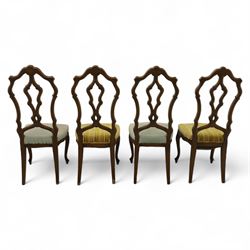 20th-century set of four French provincial-style stained beech dining chairs, pierced cartouche back with fan carving, with a scroll moulded frame above a padded serpentine seat on cabriole legs 
