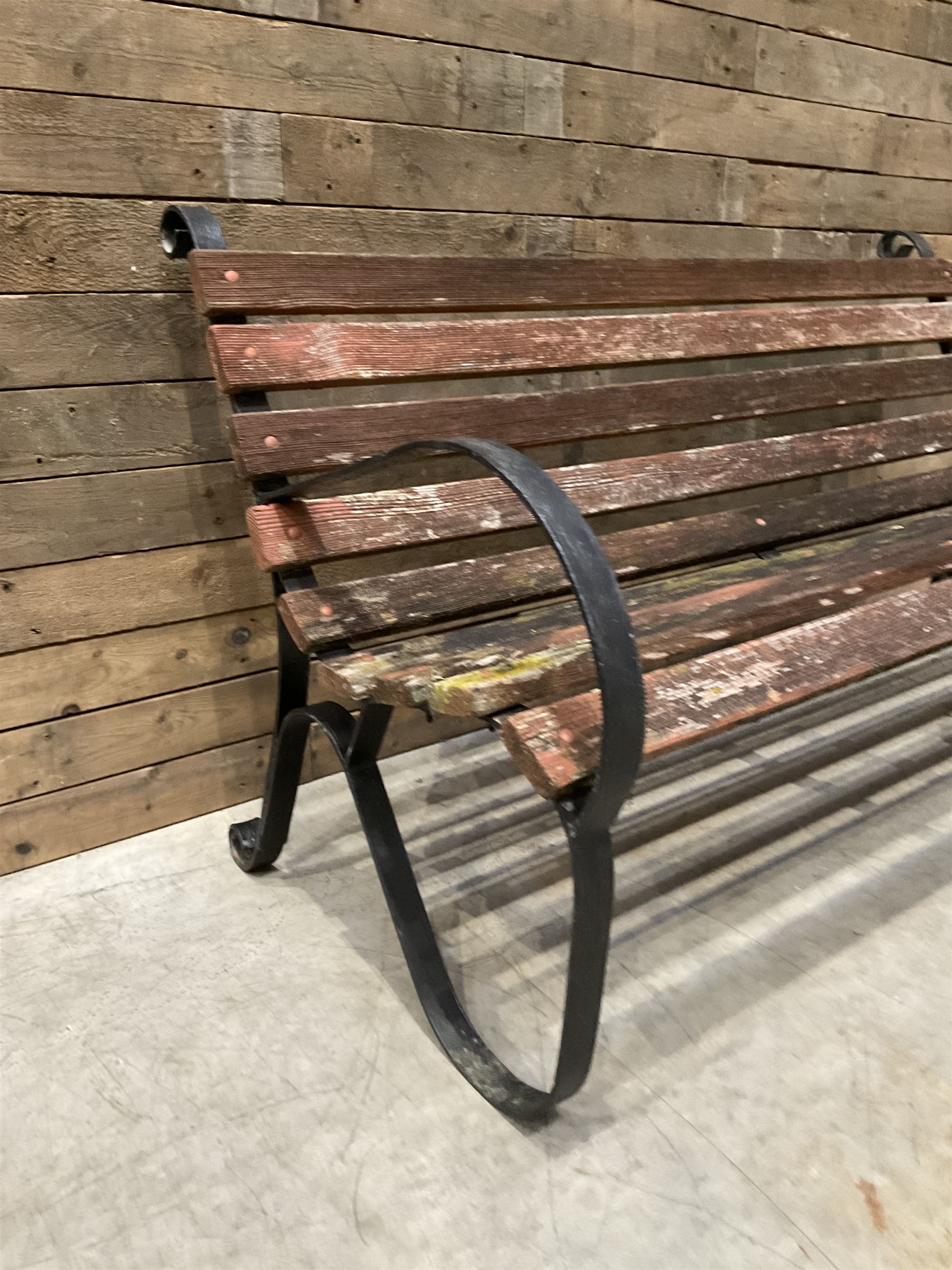 Early 20th century black painted wrought iron and wood slatted garden bench