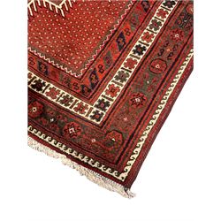 Persian Kelardasht red ground rug, the field decorated with two geometric medallions, multi-band border decorated with stylised flower heads and geometric repeating patterns