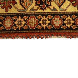 Afghan Gazni Kazak rug, the hand-knotted wool pile featuring a rust red ground with all-over geometric floral motifs in ivory and dark green, enclosed by a wide ivory border with stylised rosettes and angular vine decoration, fringed ends, from the region of Ghazni, Afghanistan
