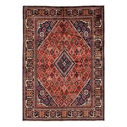 Persian Joshgan red ground rug, the medallion, field and spandrels decorated with clusters of Pitrak and tree of life motifs, the border with repeating design decorated with stylised plant motifs, within guard stripes