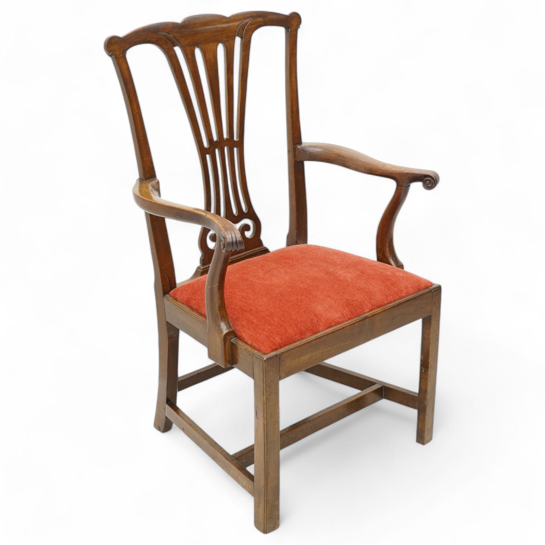 George III mahogany open elbow chair, shaped cresting rail over pierced splat, shaped arms with scroll carved terminals, drop-in seat upholstered in red fabric, on square supports with moulded edge united by plain stretchers 