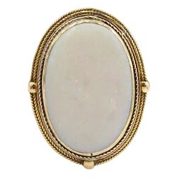 Large gold oval opal ring, with textured mount