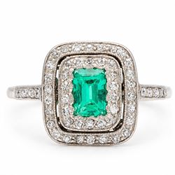 Early 20th century palladium emerald and diamond halo cluster ring, single rectangular cut...