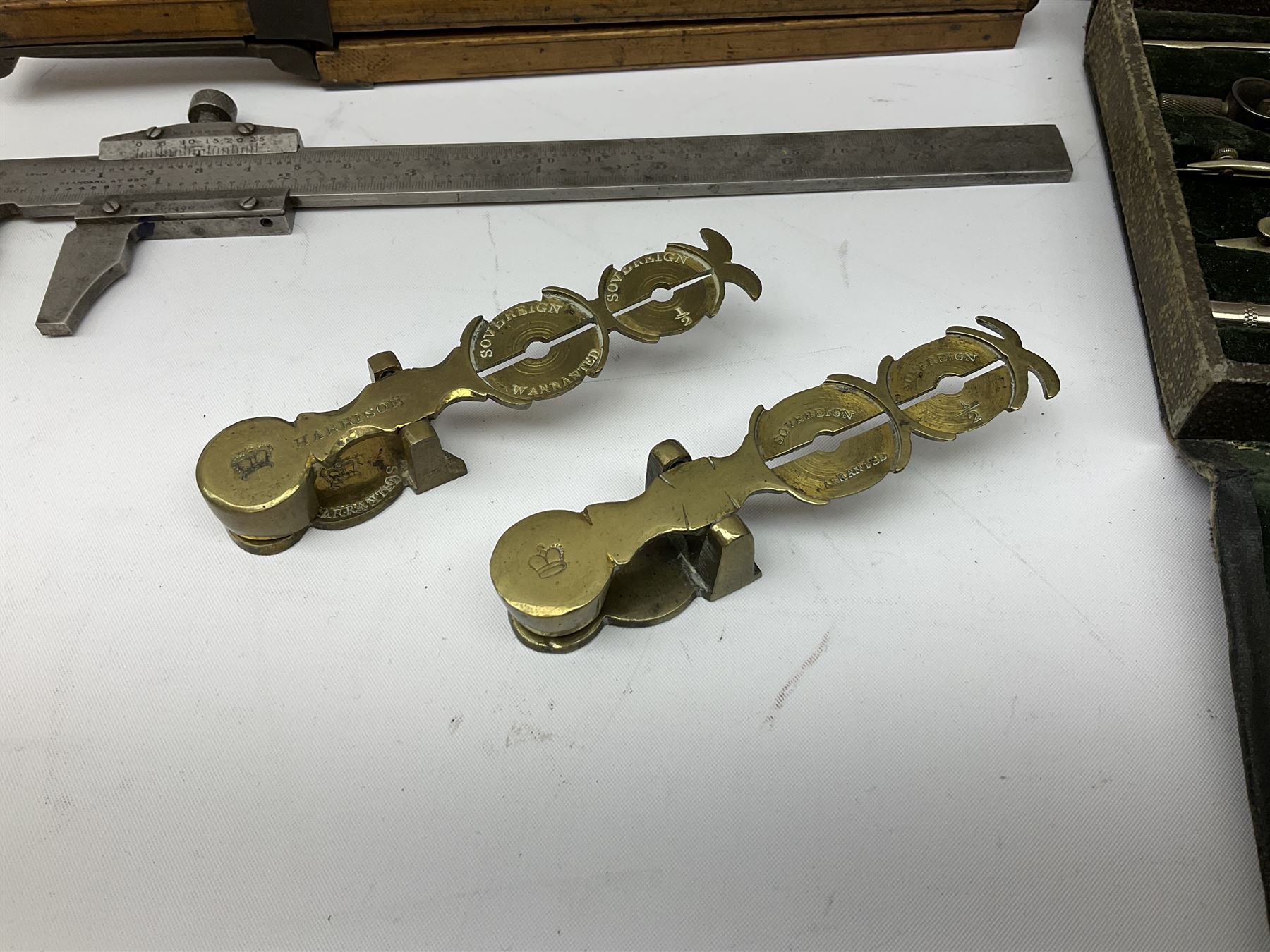 Two Victorian brass sovereign scales, one marked 'Harrison' L10cm; cased set of drawing instruments by G. Thornton Limited Manchester; Chesterman No.770/1 steel vernier caliper; two boxwood rulers; cased slide rule; brass and boxwood rope/wire gauge etc