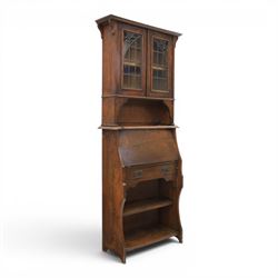 Arts & Crafts oak bureau bookcase, projecting cornice with leaded and glazed upper cabinet...