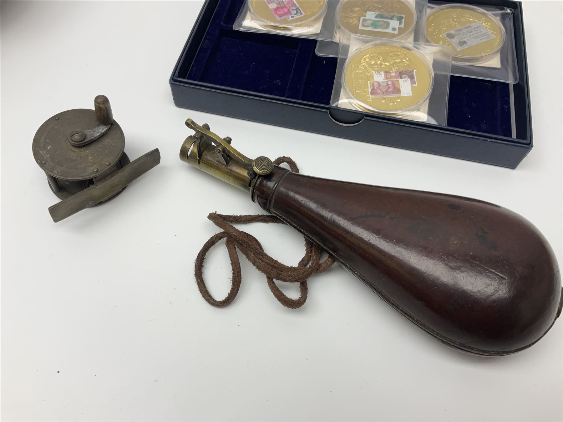 Six early 20th century fishing reels, to include wooden and brass examples, together with a leather powder flask, 1913 Christmas tin, Morgan dollar, Queen Victoria double florin and a collection of other coins, etc 