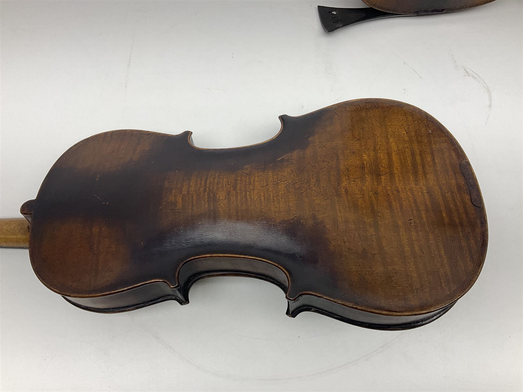 German violin c1890 with 36cm two-piece maple back and ribs and spruce top; bears label 'Antonius Stradivarius Cremona Faciebat Anno 1729' L59.5cm overall; in ebonised wooden 'coffin' case; and two German violins c1890 for completion - one bearing a Stradivarius label, the other a Ruggeri label; both in carrying cases (3)