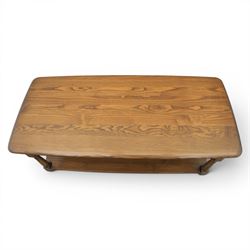 Ercol -  dark elm corner TV stand and coffee table, TV stand with drop triangular leaf, over open recess above a single drawer (H 47cm, D 44cm with leaf 79cm, W 73cm,  the coffee table with chamfered rectangular top with full length undertier, raised on turned supports (H 43cm, D 54cm, W 115cm) 