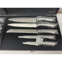 Two cased Swiss knife sets