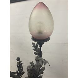 Pair of Art Nouveau style spelter figural table lamps, each mounted on rouge marble effect circular bases, with toleware flower heads and leafy decoration surrounding a female figure, H90cm