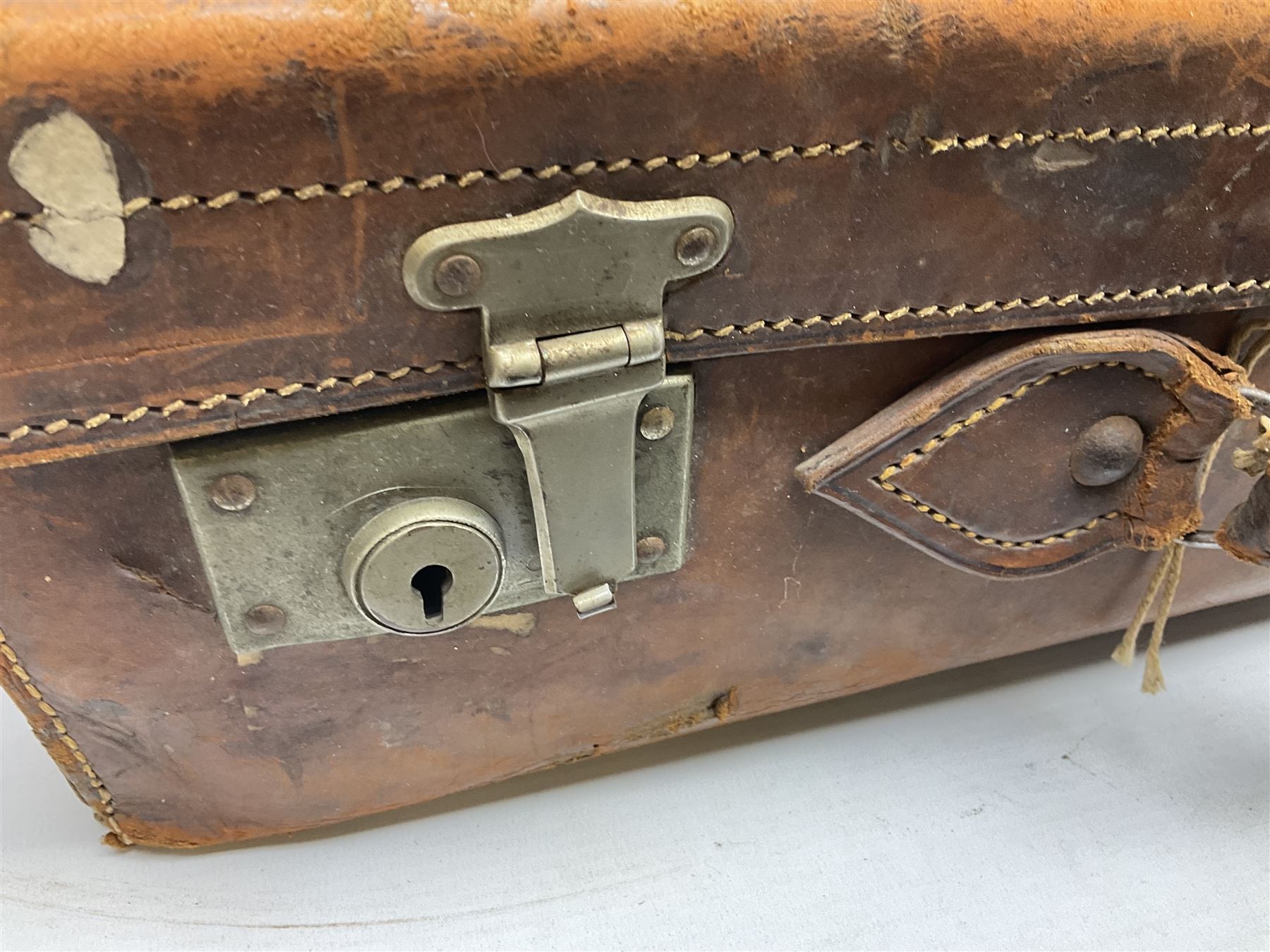 Early 20th century leather suitcase marked to the top 'Major P.M. Newton R.E. Crossways, Bridlington, East Yorkshire' 60 x 40cm; another similar leather suitcase marked W.D. to the lid; three post-WW2 respirators; and three unopened pairs of British Army N.B.C. (Nuclear Biological Chemical) No.1 Mk.III Trousers Protective (8)