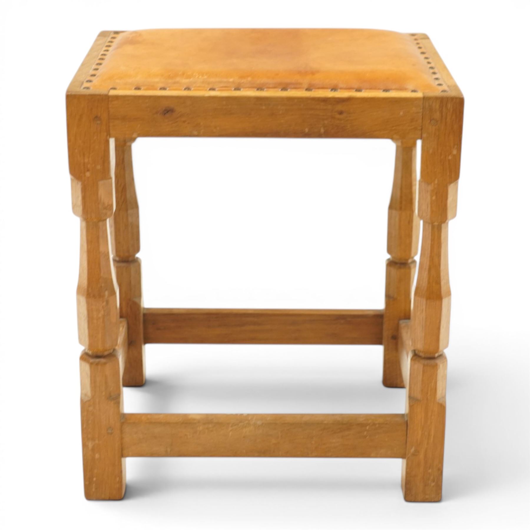 Mouseman - oak dressing table stool, the rectangular tan leather padded seat with studwork border, raised on octagonal supports united by box stretcher, carved with mouse signature, by the workshop of Robert Thompson of Kilburn