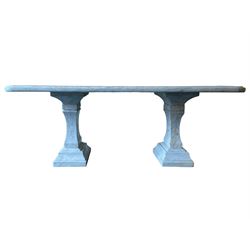 Classical Grecian design Carrera marble centre table, the rectangular single slab top with rounded corners and carved edge, raised on twin pedestals comprised of three pieces with a waisted column on a stepped plinth