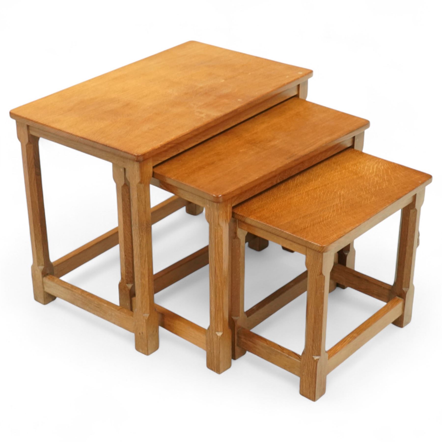 Mouseman - nest of three oak occasional tables, rectangular adzed top, on octagonal supports united by plain stretchers, each carved with mouse signature, by the workshop of Robert Thompson, Kilburn