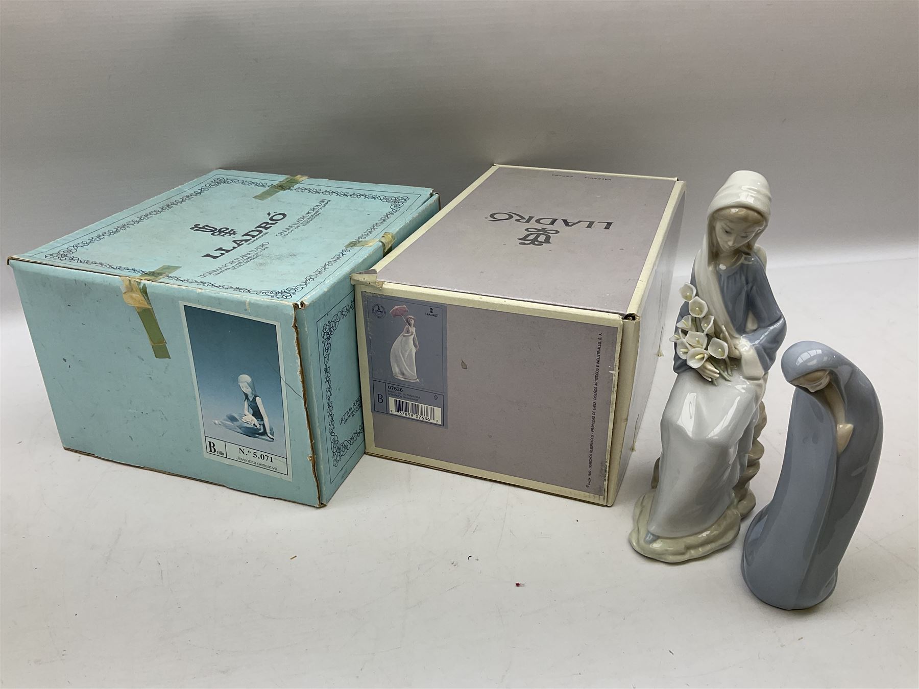 Four Lladro figures, comprising Afternoon Promenade no 7636, Nostalgia no 5071, both with original boxes, Girl with Lilies no 4972 and Madonna no 4534, largest example H27cm