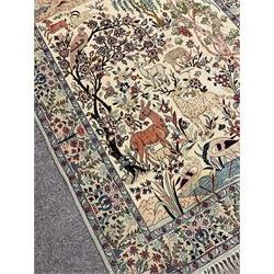 Fine Persian tree of life rug wall hanging, ivory ground field depicting landscape filled with animals, birds and flowers, the guarded border with stylised flower heads and foliage decoration, with brass hanging rail