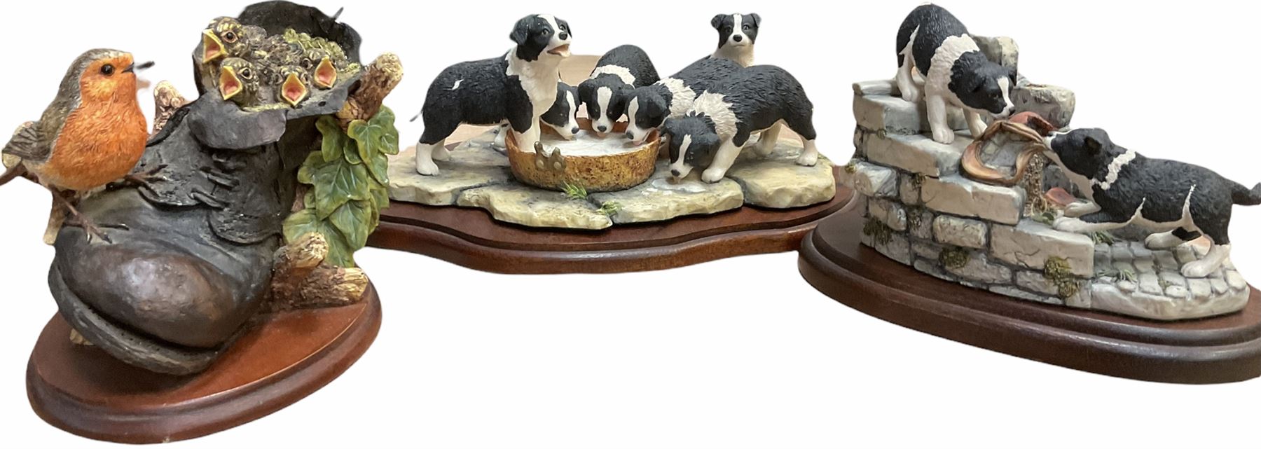 Border fine arts figures, Pick of the litter, model no JH30, by Ray Ayres L26cm, Tug of war, model no JH61, by D Walton H11.5cm and Robin with chicks in boot, model no RB45, by by Ray Ayres H11cm.  