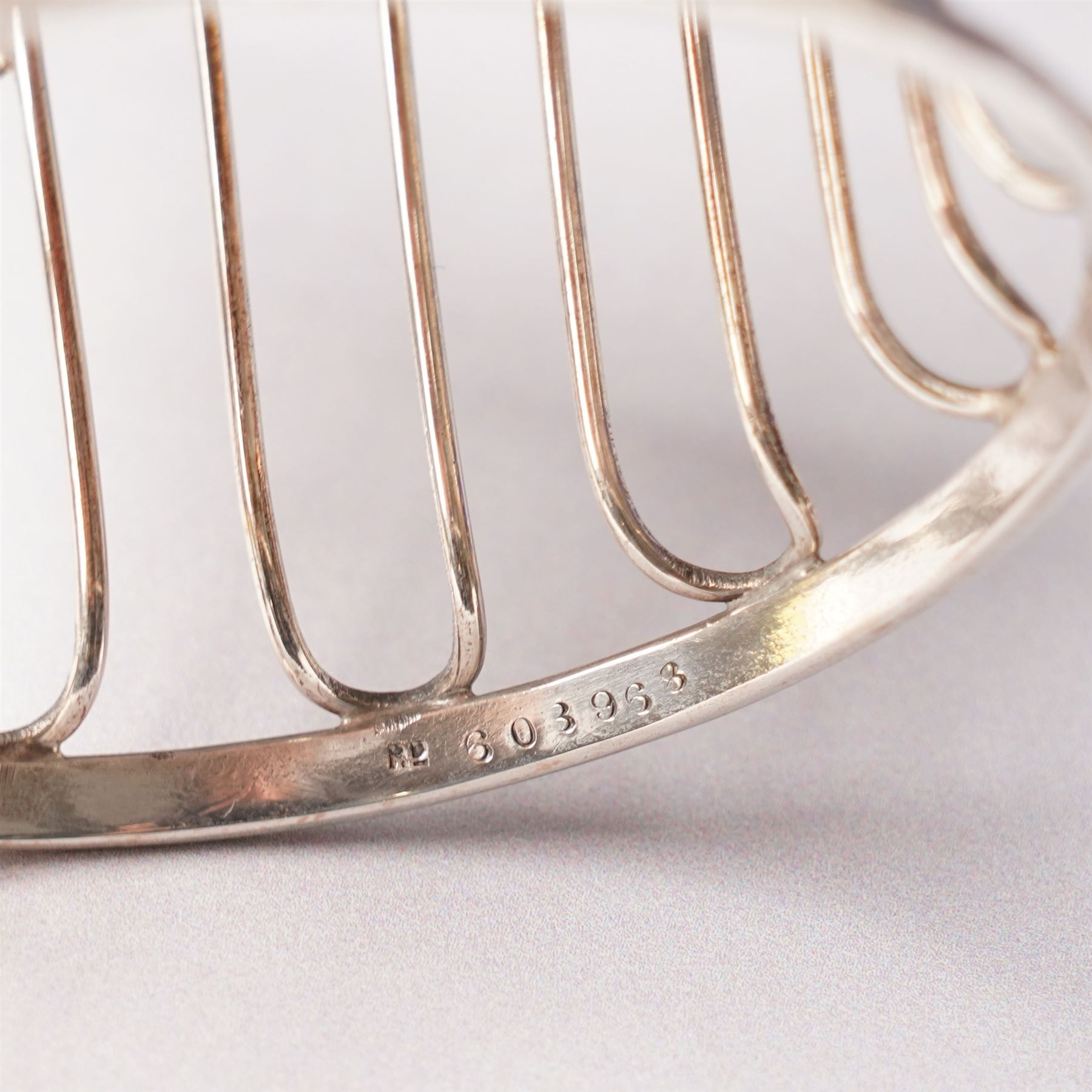 Edwardian pierced silver sugar basket with swing handle and blue glass liner H9cm London 1906 Maker Haseler Bros. and another decorated with floral swags Chester 1912 Maker  (2)