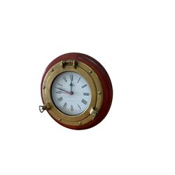 20th century marine clock with a mahogany surround and cast brass “porthole” bezel, with a 6” dial and Swiss battery operated quartz movement.