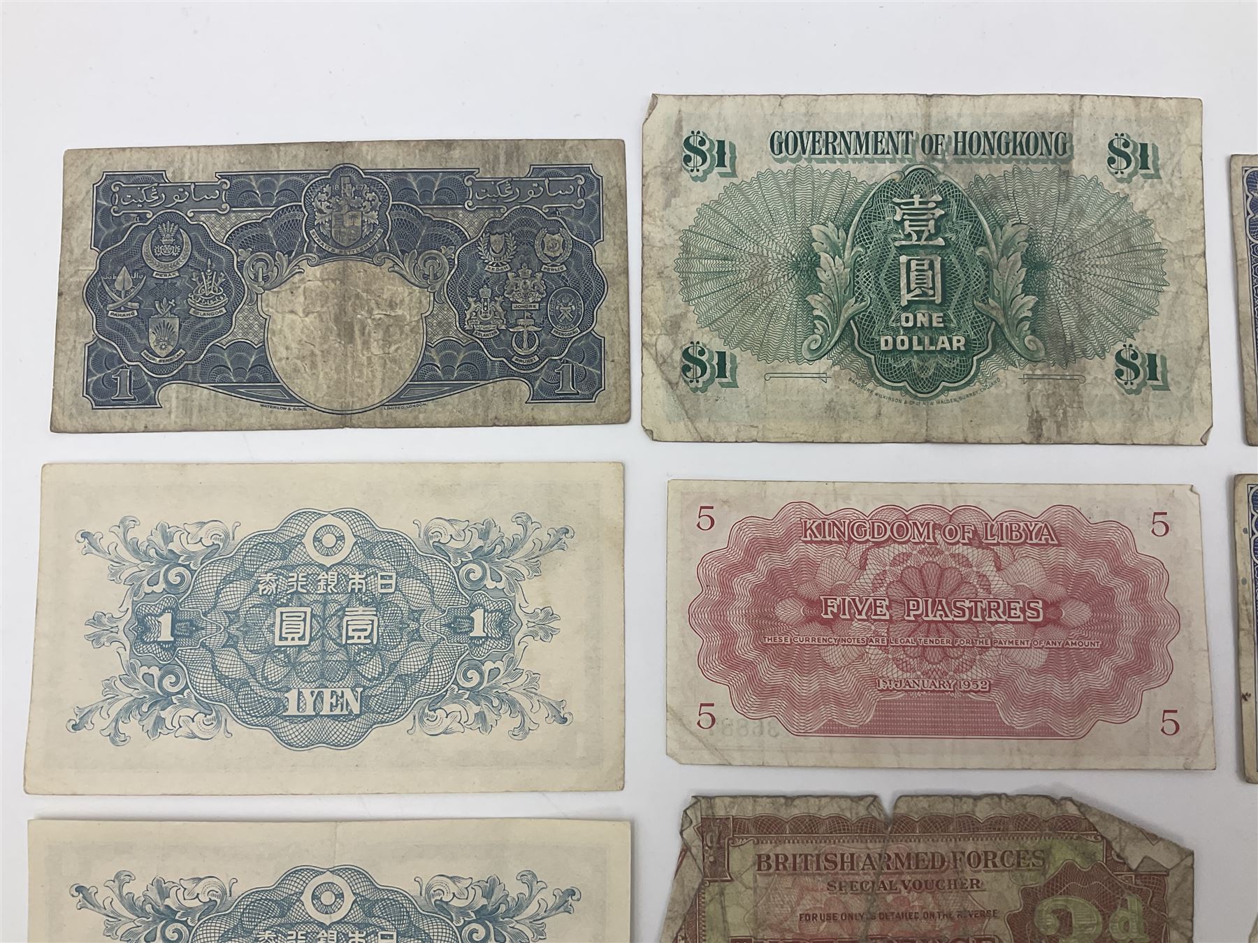 Banknotes including King George VI board of commissioners of currency Malaya one dollar 1st July 1941 'P/59 030908', Queen Elizabeth II Government of Hongkong one dollar 1st July 1952 'F/6 202153' etc