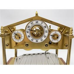 Mid 20th century 'Congreve' rolling ball clock, sloped arch and pierced brass movement, the central Arabic minute chapter ring flanked by hour and seconds dials, twin train driven eight day movement, raised on mahogany plinth with turned brass feet, under acrylic cover