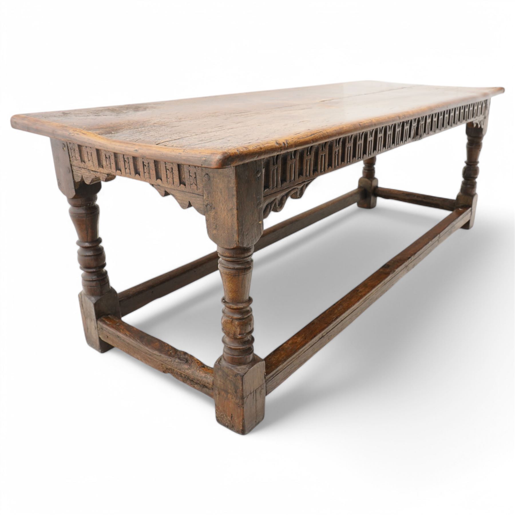 Charles I rectangular joined oak and elm refectory table, the frieze carved with repeated arch motifs, pearwood top above four turned supports united by horizontal stretcher, first half 17th century
Provenance: Purchased from Thorpe & Foster of Dorking in 1971

