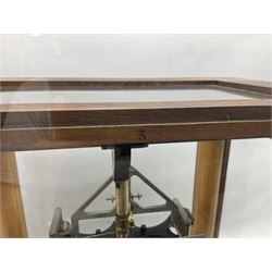 Set of laboratory balance scales by Reynolds & Branson of Leeds in fully glazed mahogany case with rise-and-fall front door, black vitrolite base with brass feet and hand cranked action L40cm H51.5cm D30cm; and bakelite cased set of brass weights