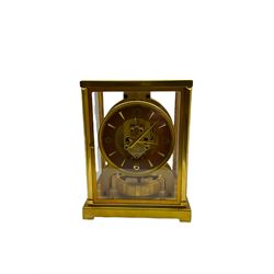 A 1950’s  gilt brass cased Jager- LeCoultre Atmos Clock, 15 jewelled Swiss movement inscribed LeCoultre Atmos with the serial number 71619 , five glazed panels, chapter ring with applied Arabic and baton hours with matching hands, skeletonised movement with oscillating balance wheel beneath, three leveling feet to the base and pendulum lock, with original booklet.
Created by the Jaeger LeCoultre watchmakers in 1928 the Atmos clock receives its power from minute changes in atmospheric temperature, hence the clocks name.  Within a sealed capsule, a mixture of gases expand and contract with each temperature change. At a temperature between 15° and 30° Celsius, a variation of a single degree is enough to power the clock for two days. In order to operate, the clock functions with an almost complete lack of friction. 
