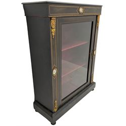 Late Victorian ebonised pier display cabinet, decorated with sèvres style porcelain panels and ornate gilt brackets, lined interior enclosed by single glazed door plinth base on turned feet