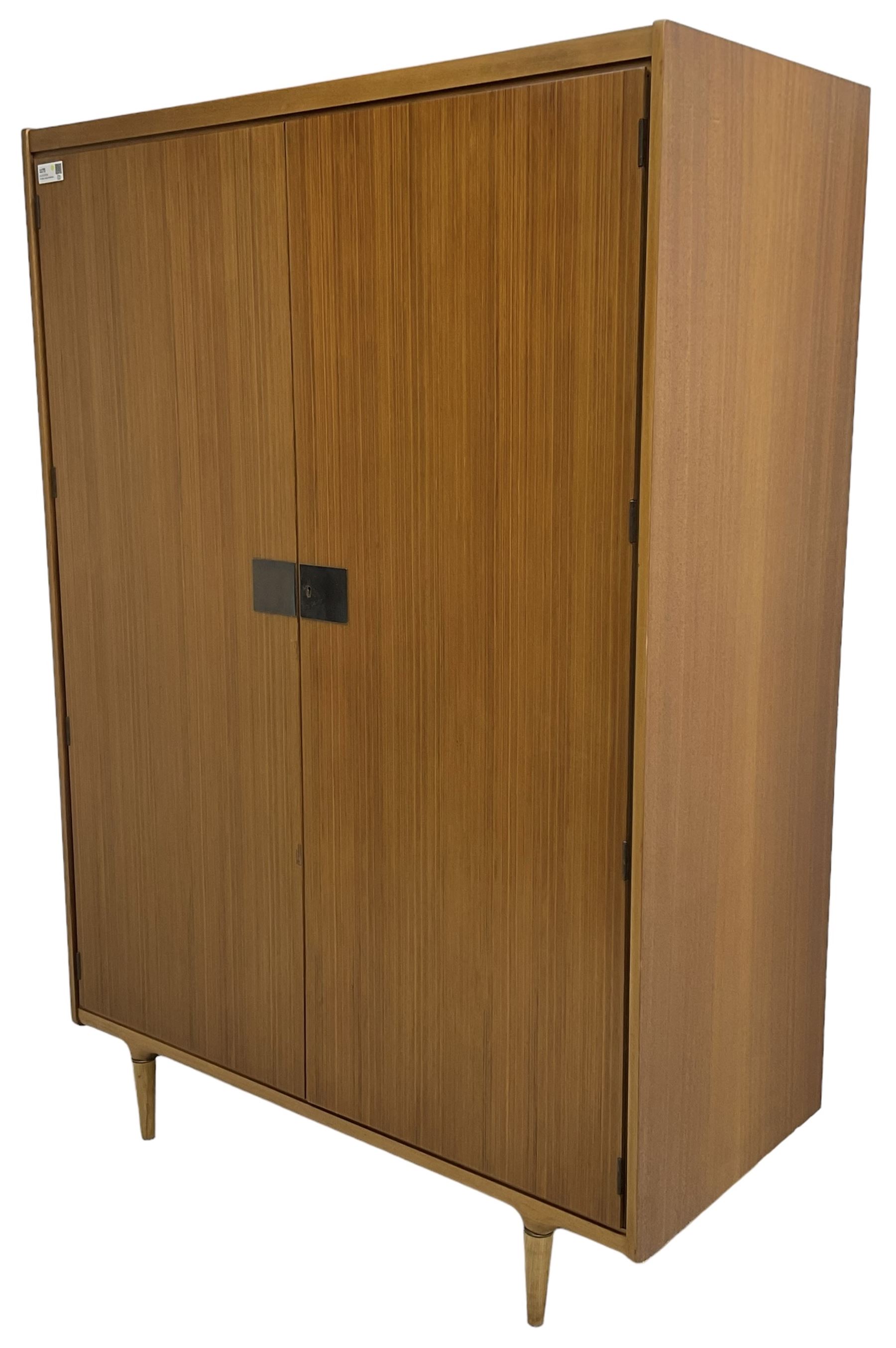 Wrighton - mid-20th century teak wardrobe, two doors enclosing hanging rail, shelves and hinged compartments, on turned tapering feet